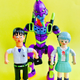 Three resin figures—a surprised boy, a smiling girl, and a giant, purple robot—on a pale yellow background.
